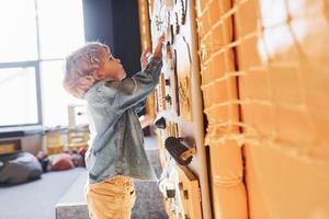 Children have fun in playroom near the wall. Kindergarten educational games photo