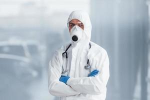 Male doctor scientist in lab coat, defensive eyewear and mask photo