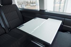 Inside of modern new automobile with black interior and table photo