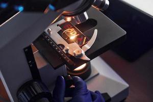 vista de cerca del científico en uniforme protector que trabaja con ébola en laboratorio foto