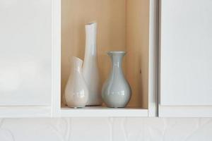 Three vases standing inside of the wall indoors at domestic room photo