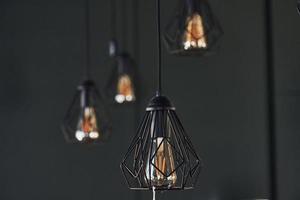 Modern designed light bulbs hangs on the wall indoors. Decoration and domestic life photo