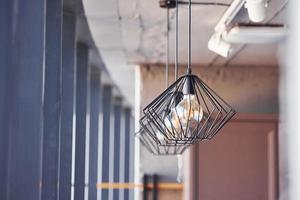 Interior of modern kitchen with light bulbs hanging indoors at daytime photo