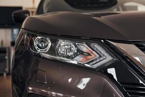 Particle view of modern brand new black car. Front part of vehicle photo