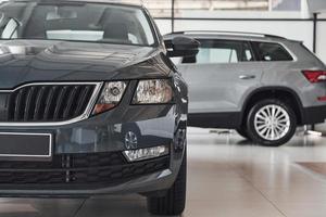 Particle view of modern brand new black and silver cars. Front and side part of vehicles photo