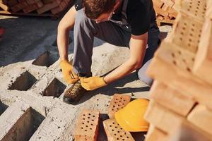 Close up view of construction worker in uniform and safety equipment preparing for the job photo