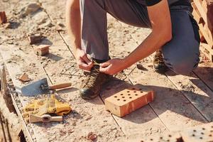 Close up view of construction worker in uniform and safety equipment preparing for the job photo