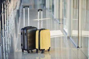 Black and white suitcases in airport hall at daytime photo