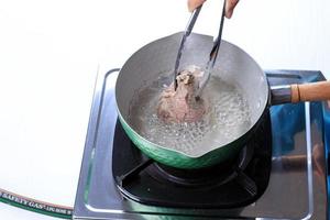 Woman Hand Boiled Beef on The Pan photo