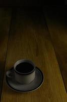 cup of black coffee on a wooden background. copyspace area photo