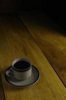 cup of black coffee on a wooden background. copyspace area photo