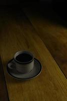 cup of black coffee on a wooden background. copyspace area photo