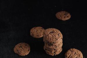 Chocolate chip cookies on black background photo