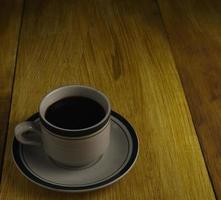 cup of black coffee on a wooden background. copyspace area photo