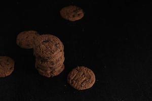 Chocolate chip cookies on black background photo