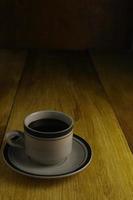 cup of black coffee on a wooden background. copyspace area photo