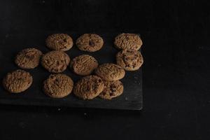 Chocolate chip cookies on black background