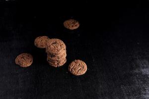 Chocolate chip cookies on black background photo