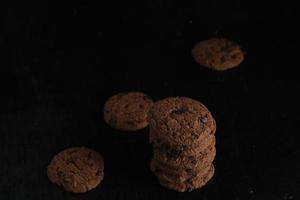 Chocolate chip cookies on black background photo
