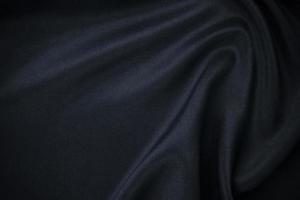 Modern dark gradient blue silk satin background. nice Soft folds on shiny fabric. Luxury background with spacing for text, design. Web banner. Flat lay, top view picture. photo