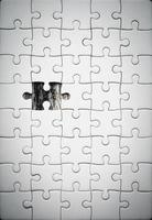 White details of jigsaw puzzle piece on wooden background. Concept of working together as a business team. The idea of getting involved, working for success. photo