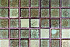 A wall from glass squares green color for background. photo