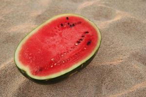 Travel to Koh Lanta, Thailand. A watermelon on the sandy beach on the sunset. photo