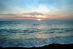 The scenic view on a sea and sand beach with colorful sunset. Phuket, Thailand. photo