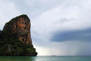 Travel to Krabi, Thailand. The scenic view on a sea with ships and the cliffs from Railay Beach. photo
