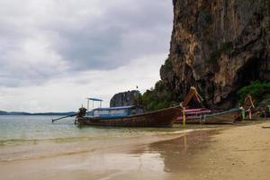 Travel to Krabi, Thailand. The view on the long boats on a coast of sea from Railay Beach. photo