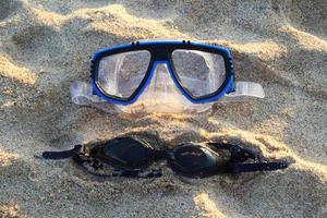 Travel to island Phuket, Thailand. Two swimming masks on the sand in the sunny weather. photo