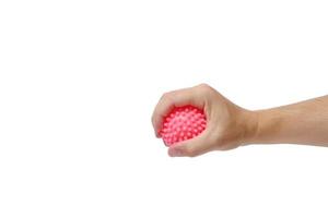 Pimply pink ball in hand, concept cellulite development. photo