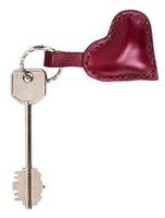llave grande con llavero en forma de corazón de cuero rojo foto