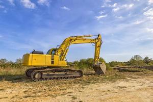 A stopping yellow excavator after work photo