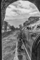 Old steam locomotive window with a view of outside. Black and white photo