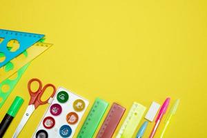 school stationery on yellow background with copy space photo