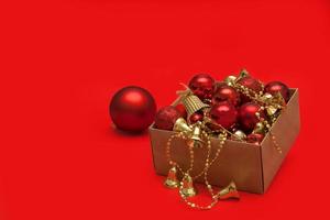 Christmas toys in a box on a red background with copy space, greeting card photo