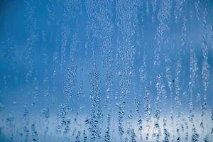 Texture of misted glass in autumn. Drops of water on window in rainy weather. photo