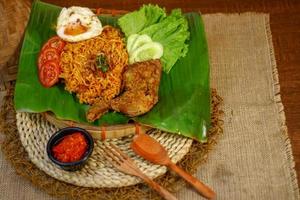 spicy noodle food with additional omelet and fried chicken photo