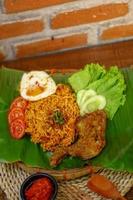 spicy noodle food with additional omelet and fried chicken photo