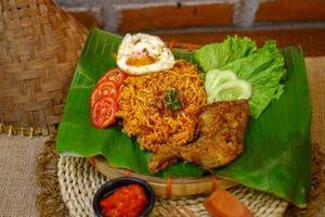 spicy noodle food with additional omelet and fried chicken photo