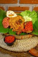 spicy noodle food with additional omelet and fried chicken photo