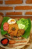 spicy noodle food with additional omelet and fried chicken photo