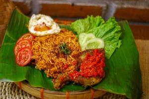 spicy noodle food with additional omelet and fried chicken photo