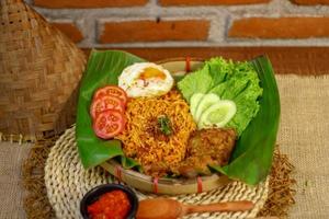 spicy noodle food with additional omelet and fried chicken photo