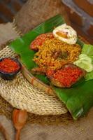 spicy noodle food with additional omelet and fried chicken photo