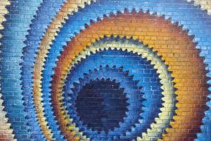 Spiral colorful pattern on a brick wall photo