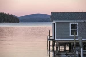 Pink rose colored sunset over a lake in the fall photo