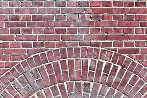 Detailed view at a colorful old and weathered brick wall texture as a panoramic background. photo