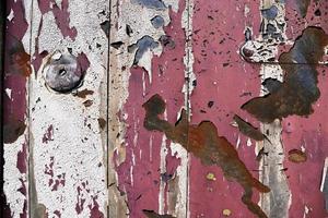 Detailed and colorful close up at cracked and peeling paint on concrete wall textures in high resolution photo